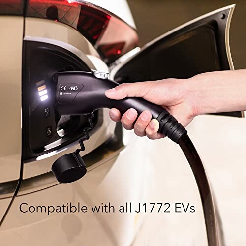 Hand plugging EV charger into J1772 electric vehicle port.