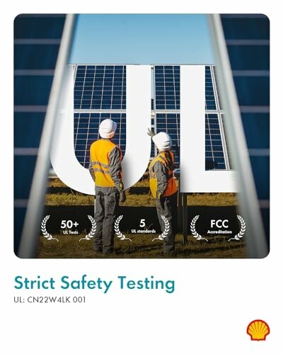 Two workers in safety gear inspecting a solar panel installation.